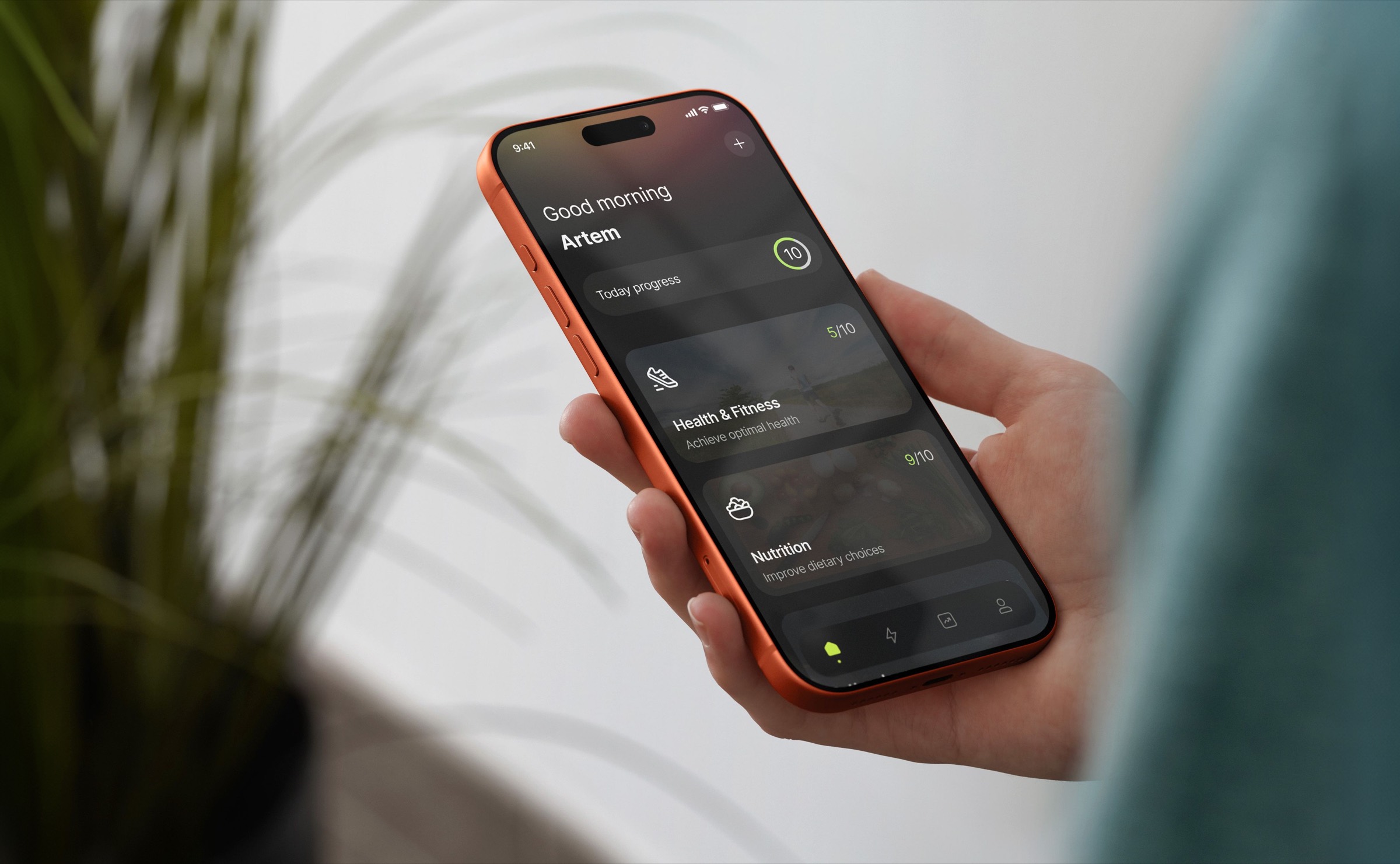 A hand holding a phone that shows the Motiway app's daily progress screen