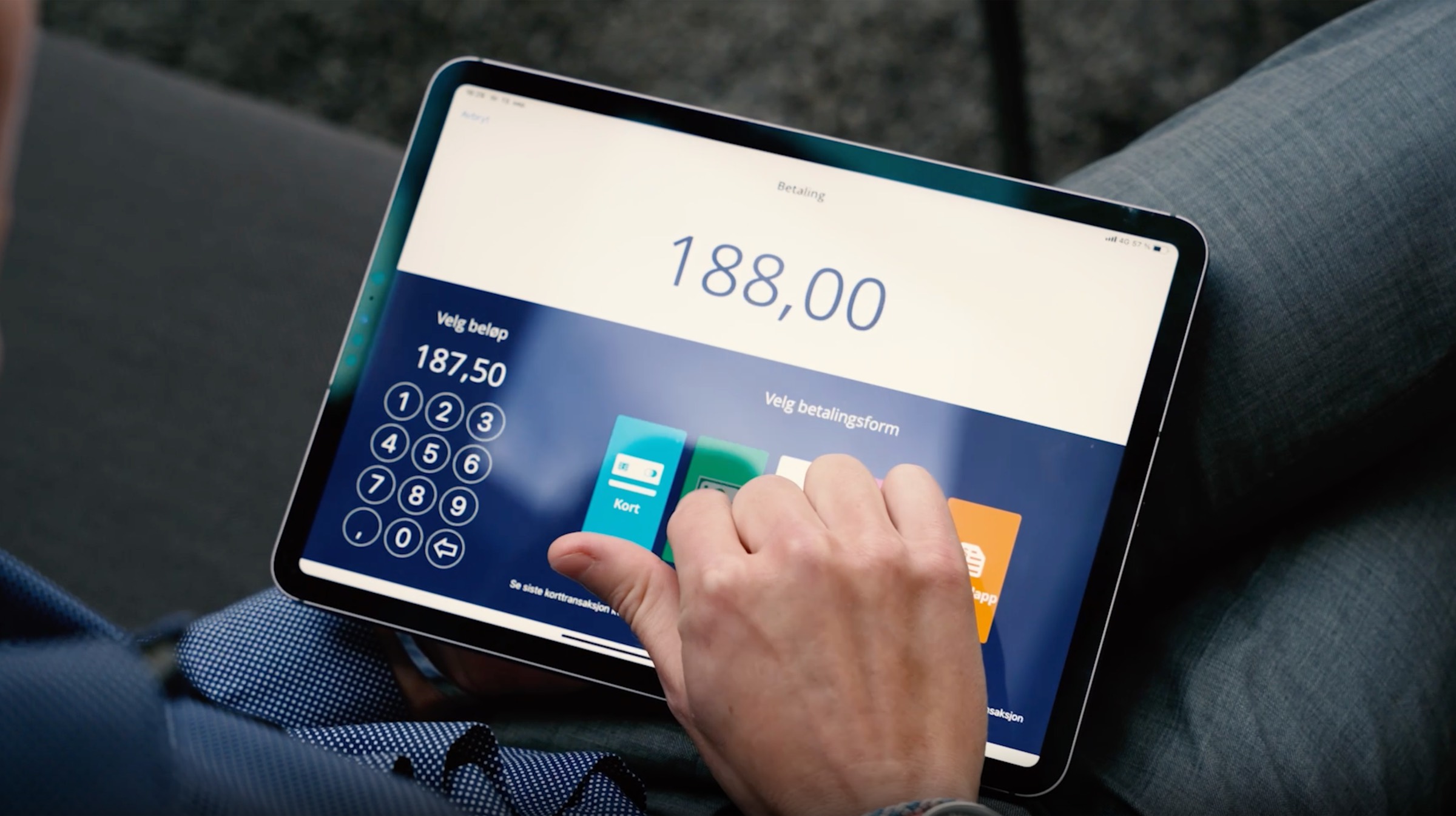 A hand tapping a payment option on a Shoplabs iPad checkout screen